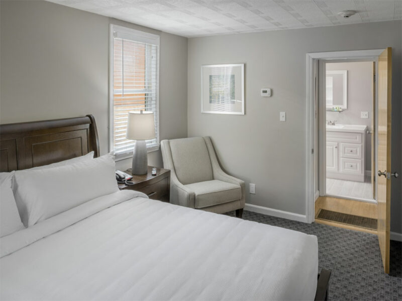 Relax in the comfort of your king bed in this lower floor suite of the standalone cottage